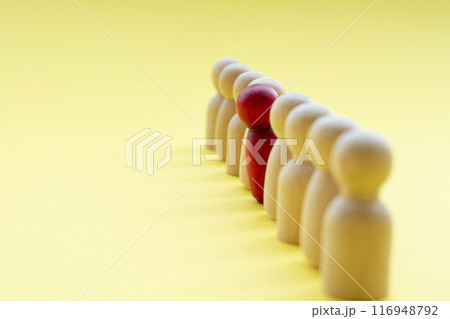 A red wooden figure looking as if he or she is disagreed with something. Concept of courage and speak up. A red wooden figure looking as if he or she is disagreed with something. Concept of courage and speak up. 116948792