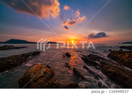 Long exposure image of Dramatic sky seascape with rocks and waves crashing on seashore in sunset or sunrise scenery background 116949037
