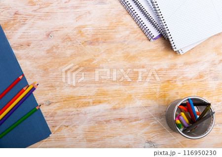 Pencils and workbooks on wooden desk 116950230