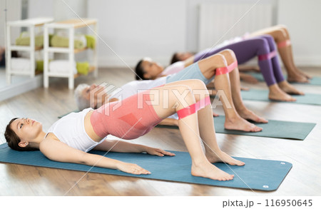 Aerobics pilates women with rubber bands in row Aerobics pilates women with rubber bands in row 116950645