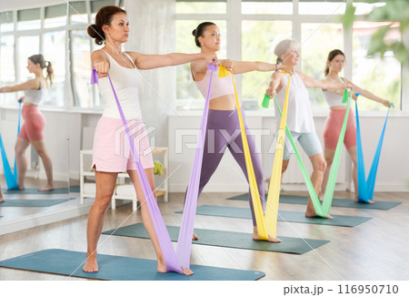 Adult woman exercising with pilates band 116950710