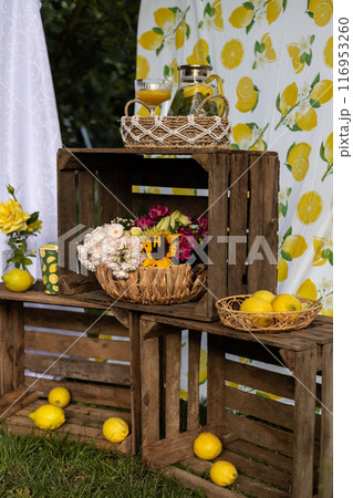 Basket of lemons. Decorations with lemons. Photo zone with citrus fruits Basket of lemons. Decorations with lemons. Photo zone with citrus fruits 116953260