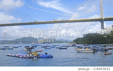 Fishing boats, car bridge, harbour and beach at sunny day 116953631