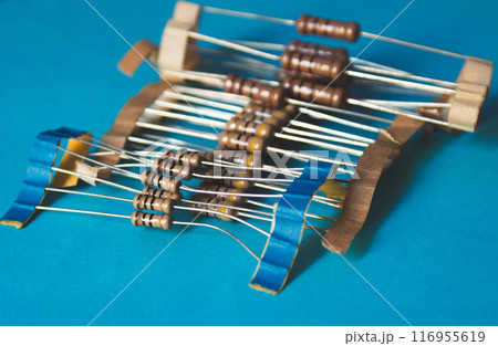 Several through hole resistors on top of a blue table 116955619