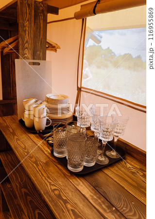 Interior of cozy open glamping tent. Camping tent for outdoor summer holiday and vacation Interior of cozy open glamping tent. Camping tent for outdoor summer holiday and vacation 116955869