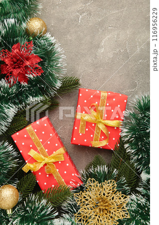 Christmas gift boxes and decorations on grey wooden table. Christmas gift boxes and decorations on grey wooden table. 116956229