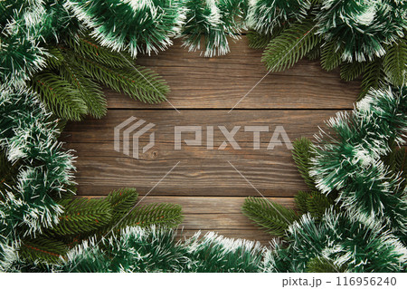 Christmas and New Year holiday background. Green tinsel and fir-tree. Frame 116956240