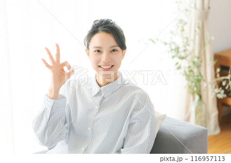 指でOKのポーズをする30代女性 116957113