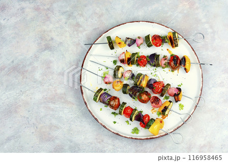 Grilled skewers vegetables on a plate. Grilled skewers vegetables on a plate. 116958465