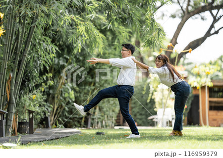 Asian Woman Grabbing and Catching Man shoulder and bracing the man to live with her. 116959379