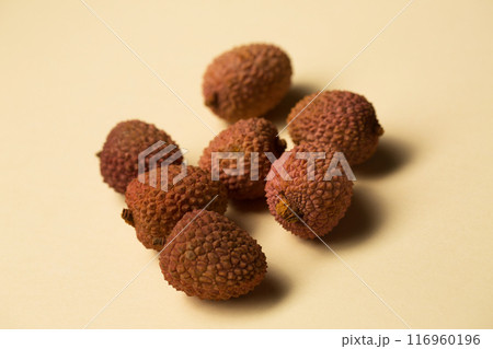 Small tropical lychee berries on a sand-colored background Small tropical lychee berries on a sand-colored background 116960196