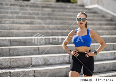 Shot of an attractive young woman taking a break during her workout in the park 116964233