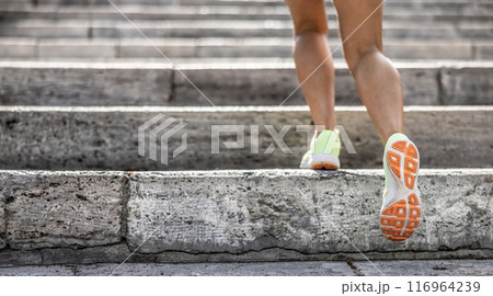 Runner athlete legs running on city stairs. woman fitness jogging workout wellness concept 116964239