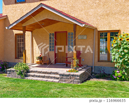 Entrance of a nice residential house with green lawn in front Entrance of a nice residential house with green lawn in front 116966635