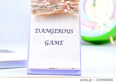 Text Dangerous game on a blank sheet of a desktop tear-off calendar Text Dangerous game on a blank sheet of a desktop tear-off calendar 116966666