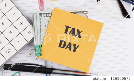 Tax Day Taxation Financial Money Money Concept. Words TAX DAY on a yellow sticker on American banknotes on the background of a business notebook Tax Day Taxation Financial Money Money Concept. Words TAX DAY on a yellow sticker on American banknotes on the background of a business notebook 116966675
