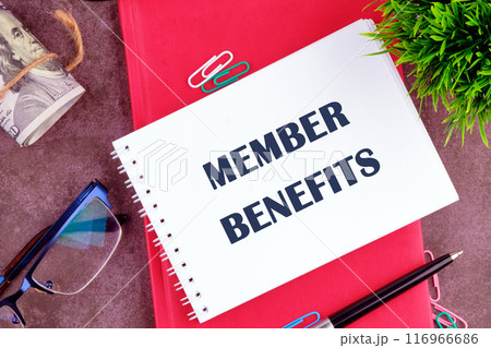Member Benefits, e-commerce conceptual. MEMBER BENEFITS words written in a notebook on a blank sheet in a composition with glasses, dollars, a pen and an ornamental plant 116966686