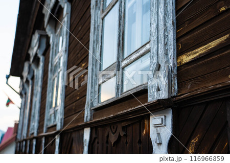 An old, vintage, wooden building. White, wooden windows in it An old, vintage, wooden building. White, wooden windows in it 116966859