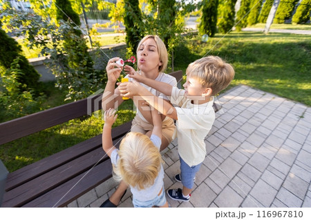 Mother Enjoying Playtime With Her Two Sons at the Playground on a Sunny Day Mother Enjoying Playtime With Her Two Sons at the Playground on a Sunny Day 116967810