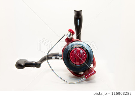 Red fishing reel for rod and spinning on white background 116968285