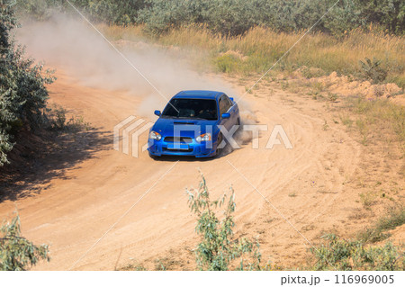 Rally Car on a Turn on a Dirt Road Rally Car on a Turn on a Dirt Road 116969005