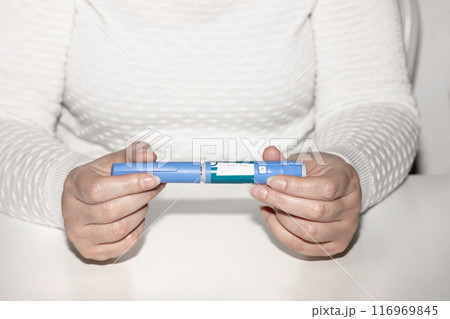 Female hands holding an insulin pen. Ozempic Insulin injection pen. 116969845