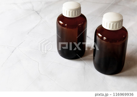 Two empty and closed brown glass medical bottle. 116969936