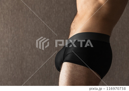 Belly and hips of a young sporty man in black boxer underpants 116970738