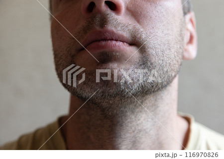 Unshaven chin and neck of an European man, close-up 116970826