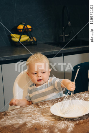 Engaging Toddlers in Whisking Activities in the Kitchen A Fun Learning Experience. Happy family enjoys moments of cooking at home. Engaging Toddlers in Whisking Activities in the Kitchen A Fun Learning Experience. Happy family enjoys moments of cooking at home. 116971103