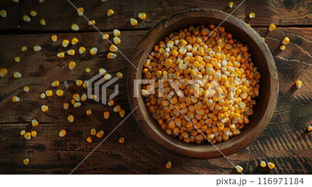 Bowl with corn seeds and ripe corn cobs on wooden table 116971184