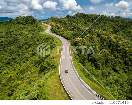 Aerial view of car driving on beautiful steep curved road (look like number 3) on the high mountain in Nan province, Thailand. 116971416