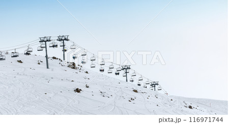 Ski lift on snowy slope at ski resort 116971744