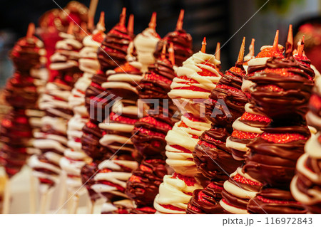 Chocolate coated fresh strawberry skewers at fruit stall at famous Barcelona food market La Boqueria Chocolate coated fresh strawberry skewers at fruit stall at famous Barcelona food market La Boqueria 116972843