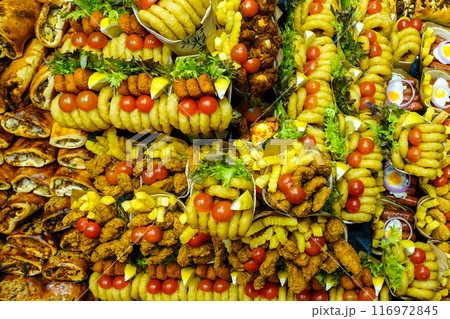 Appetizing colorful street fast food servings at a market stall, La Boqueria food market, Barcelona 116972845