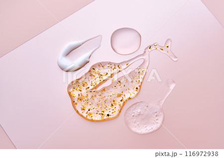 Texture of face serum, cream, oil and serum with 24k gold on a pink background. 116972938