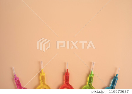 Flatly Many Colorful Interdental Toothpicks, Dental Brush Angle for Teeth Cleaning, Braces On Yellow Peach Background. Dentistry, Oral Health Hygiene. Copy Space. Flossing Oral Brush, Horizontal Flatly Many Colorful Interdental Toothpicks, Dental Brush Angle for Teeth Cleaning, Braces On Yellow Peach Background. Dentistry, Oral Health Hygiene. Copy Space. Flossing Oral Brush, Horizontal 116973687