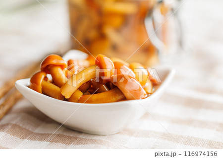 Pickled nameko mushrooms.Traditional japanese mushrooms in bowl on checkered tablecloth. 116974156