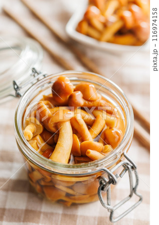 Pickled nameko mushrooms.Traditional japanese mushrooms in jar on checkered tablecloth. 116974158