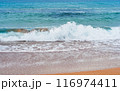 Enjoy the calm of a sandy beach with gentle waves and 116974411