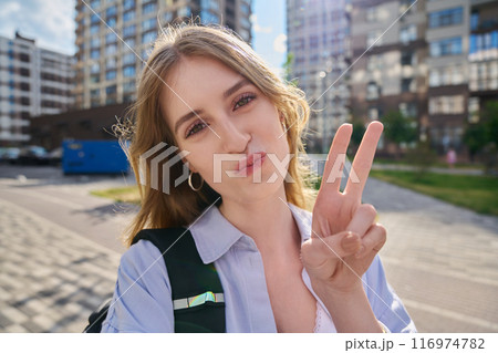 Selfie portrait of young happy blonde female looking at camera outdoor Selfie portrait of young happy blonde female looking at camera outdoor 116974782