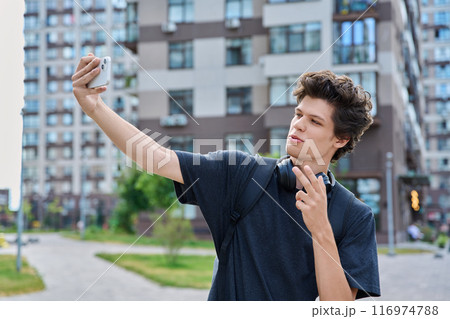 Young guy student with smartphone in his hands taking selfie outdoor portrait 116974788