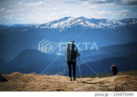 Young female travelers walk the trail on the mountainside 116975094