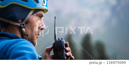 A mountain rescuer, man with a walkie-talkie. 116975099
