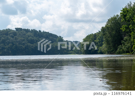 A gorgeous view of water near trees and plants at a local park in Minnesota. A gorgeous view of water near trees and plants at a local park in Minnesota. 116976141