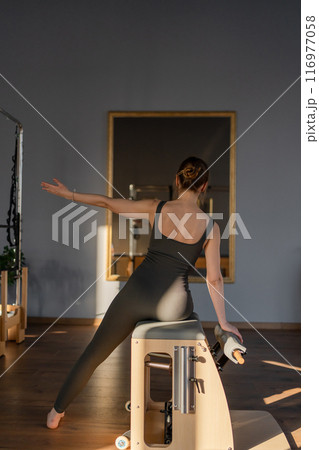 Woman doing mermaid exercise in a sunlite modern studio, embodying calm, focus, and strength. Woman doing mermaid exercise in a sunlite modern studio, embodying calm, focus, and strength. 116977058