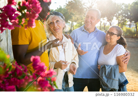 Portrait of mature males and females talking outdoors Portrait of mature males and females talking outdoors 116980332