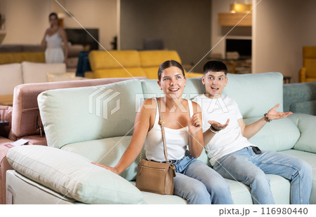 Couple man and woman choosing sofa in store Couple man and woman choosing sofa in store 116980440