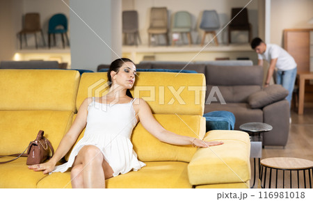 Adult woman chooses sofa in store 116981018