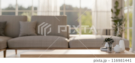 A space for displaying products on a wooden coffee table in a contemporary Scandinavian living room. A space for displaying products on a wooden coffee table in a contemporary Scandinavian living room. 116981441